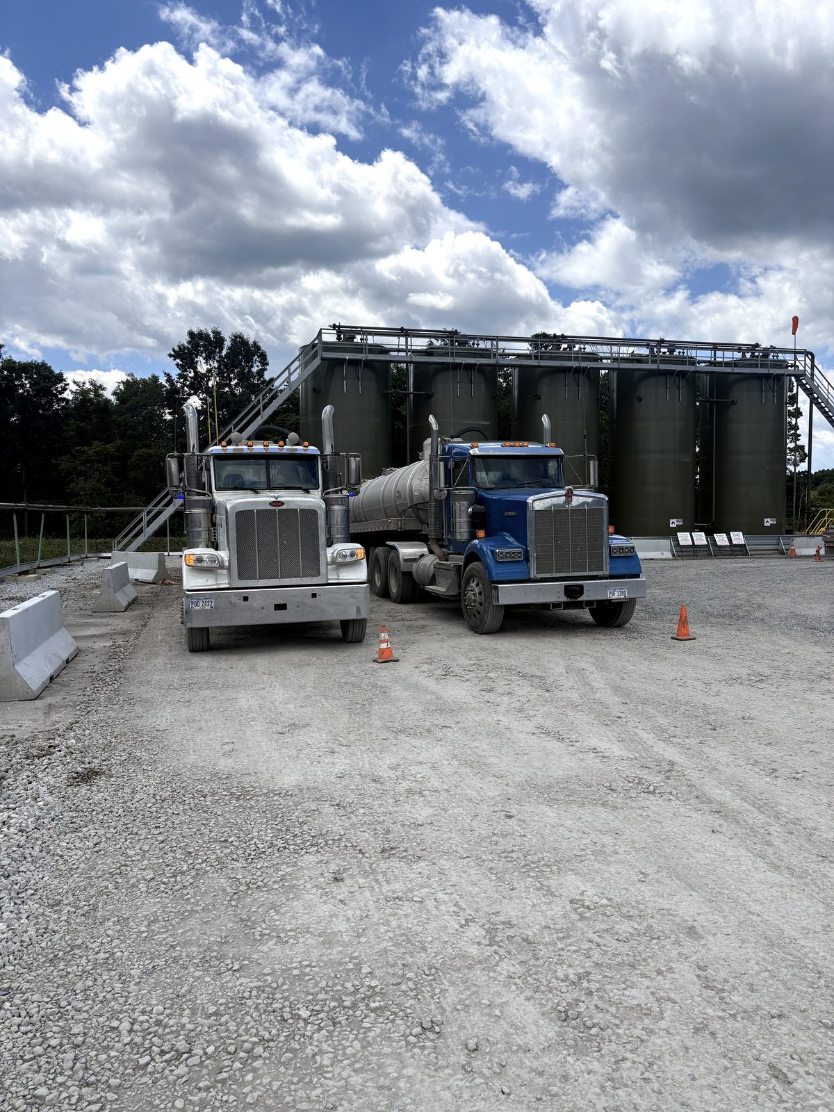 Two blue rigs staged on site